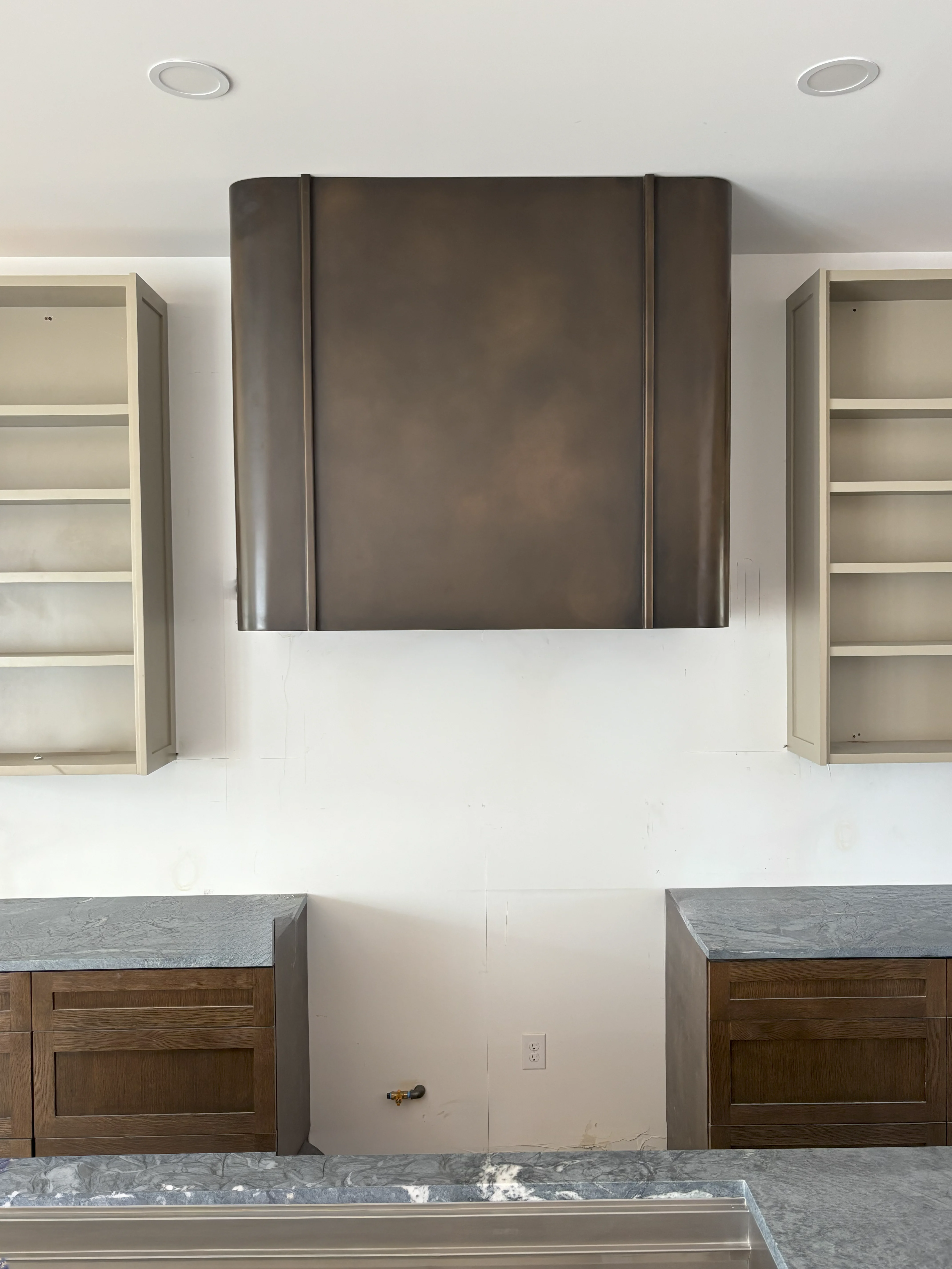Bronze hood with white subway tile